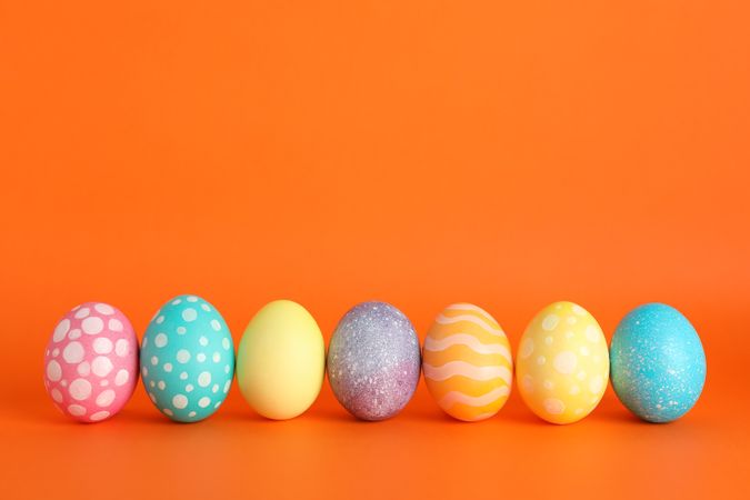 Decorated Easter eggs on color background. Space for text