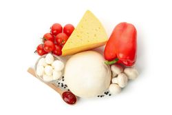 Dough and ingredients for cooking pizza isolated on blank background