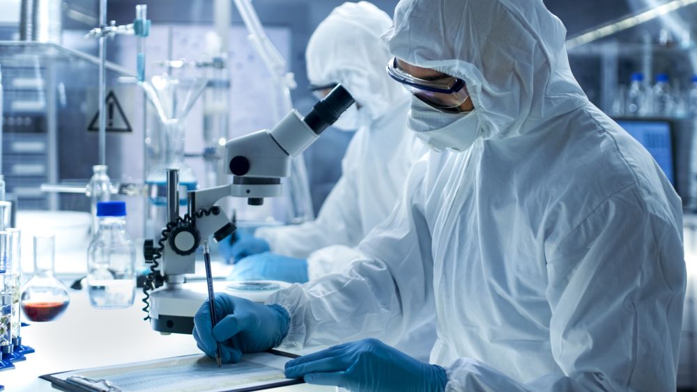 Chemist with His Colleague Writes Down Experiment Results.