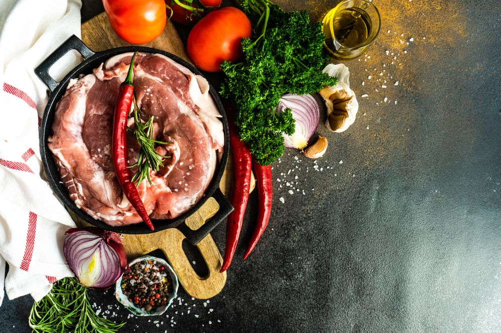 Top view of fresh raw pork ready for recipe with copy space