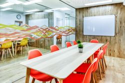 Interior of light modern office with colorful furniture against big window