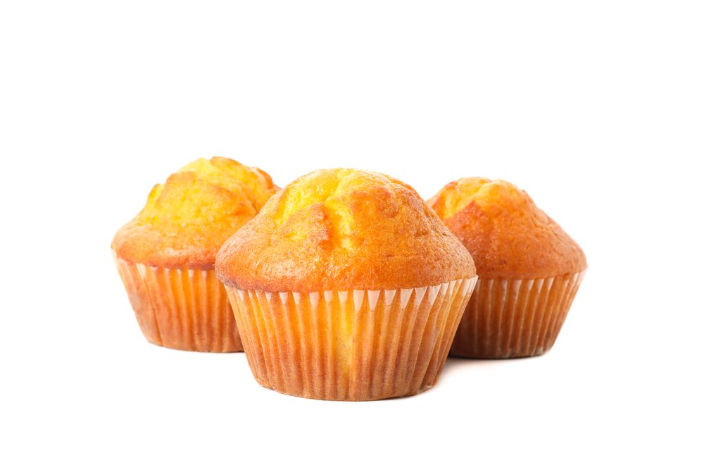 Delicious tasty muffins isolated on light background