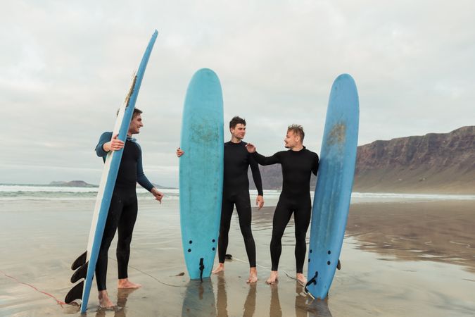 Excited men with surfboards