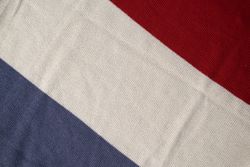 Triple color grey milk and red on knitted fabric background texture.