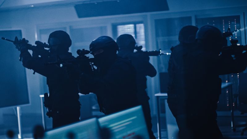 Soldiers with Rifles and Flashlights Surveil and Cover Surroundings.