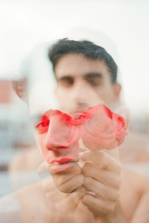 Young man with red flowers