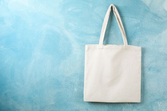 Tote cotton bag on color wall, space for text