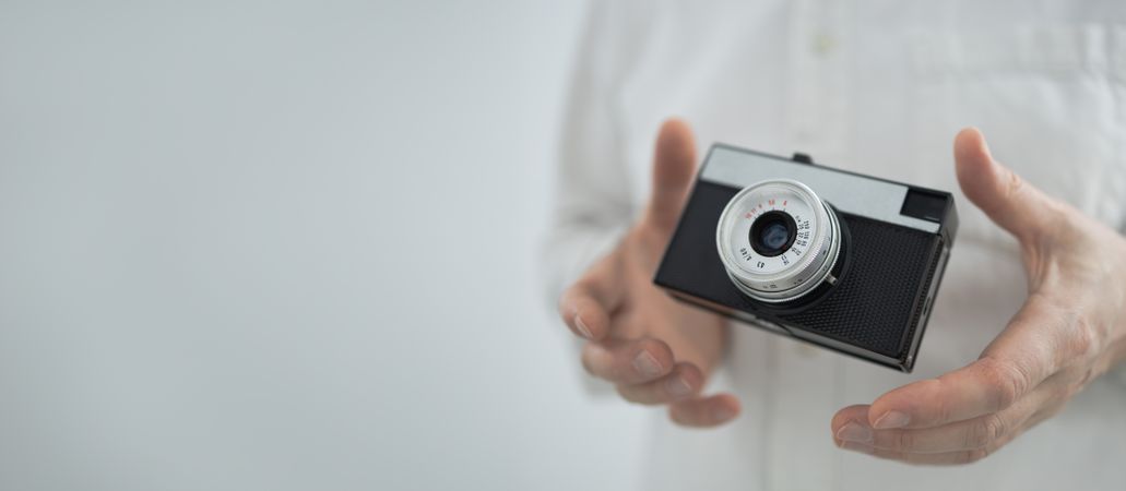 Floating retro camera in hands