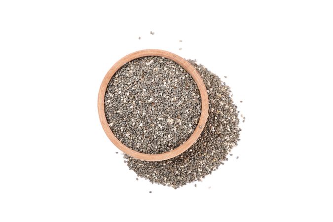 Chia seeds and wooden bowl isolated on blank background