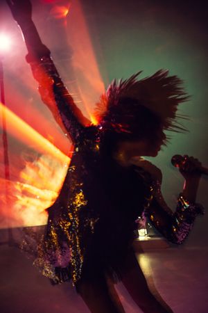 Stylish woman singing on stage