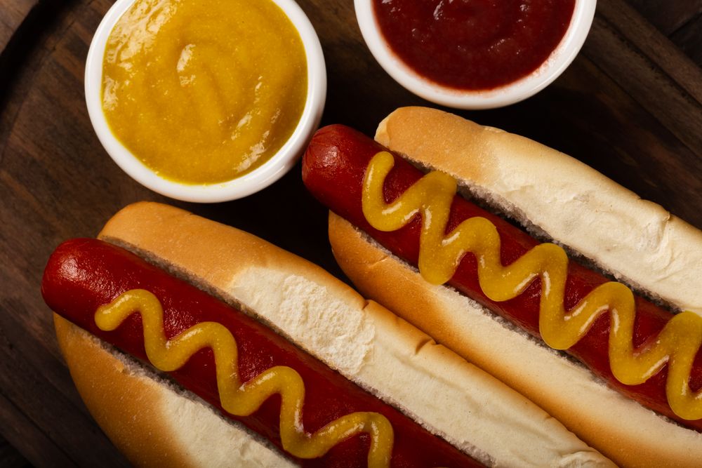 Top view close up of two hot dogs with mustard