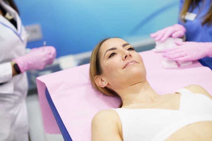 Woman laying in medical beauty spa awaiting treatment