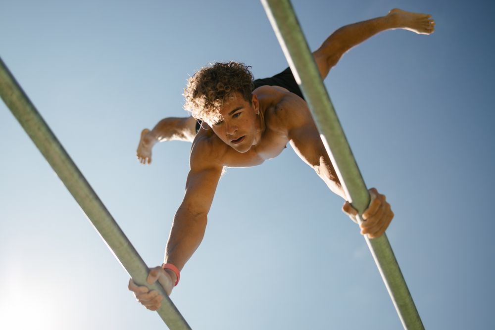 Strong young sportsman doing calisthenics