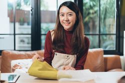 Asian female taking fabric out of bag