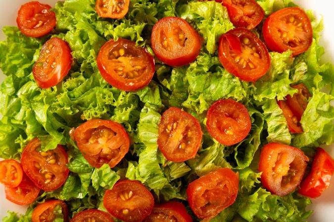 Sliced tomatoes on bed of lettuce