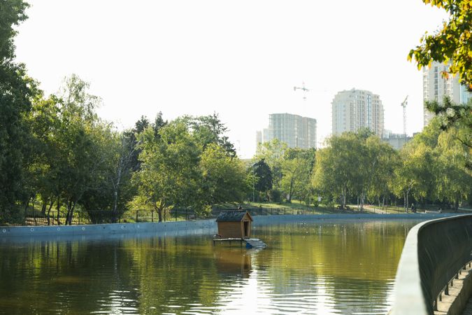 Beautiful city park with lake in sunny morning