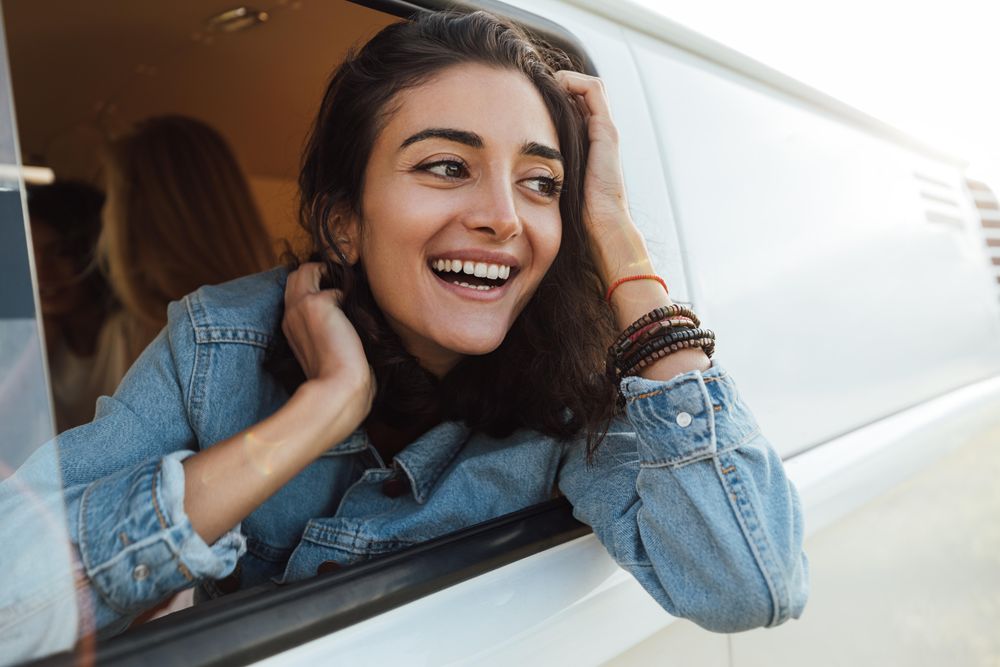 Beautiful young female looking out of the van