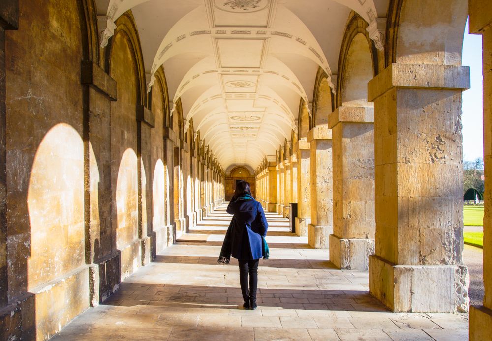 Woman in blue coat walking in hallway