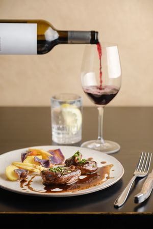Delicious dinner in restaurant with red wine and beef steaks