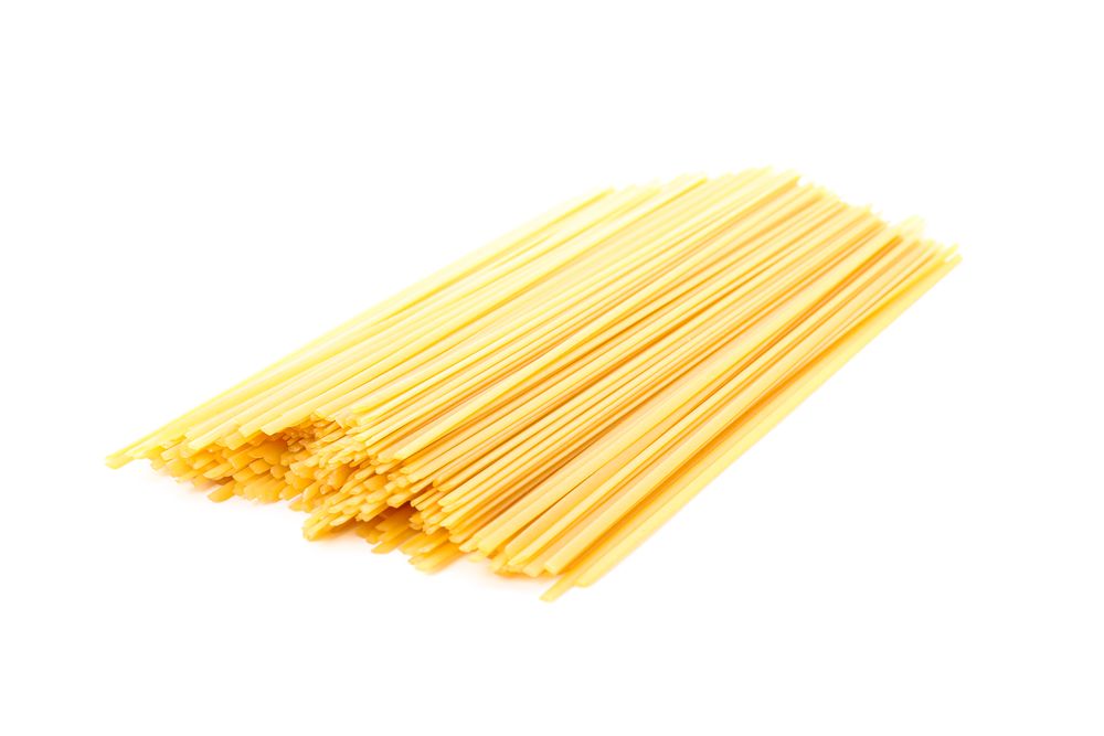 Pasta isolated on light background, closeup. Dry uncooked whole pasta