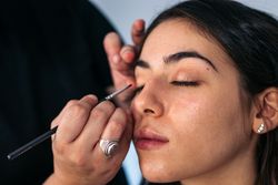 Close-up of a woman having her eyes made up