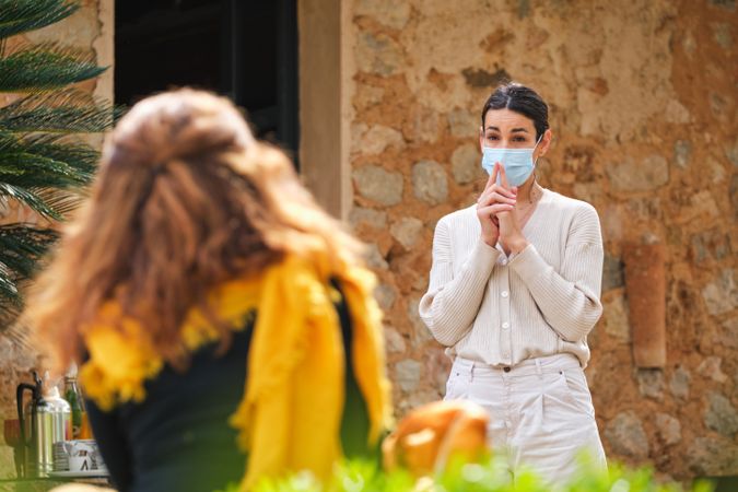 Female speaker talking to lecture listener in sunny garden