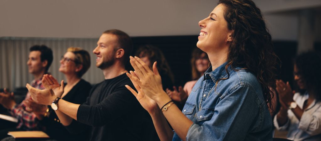 Business people clapping hands during a conference