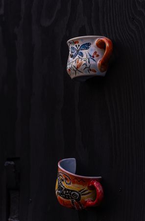 Ceramic cups as a handle on old door