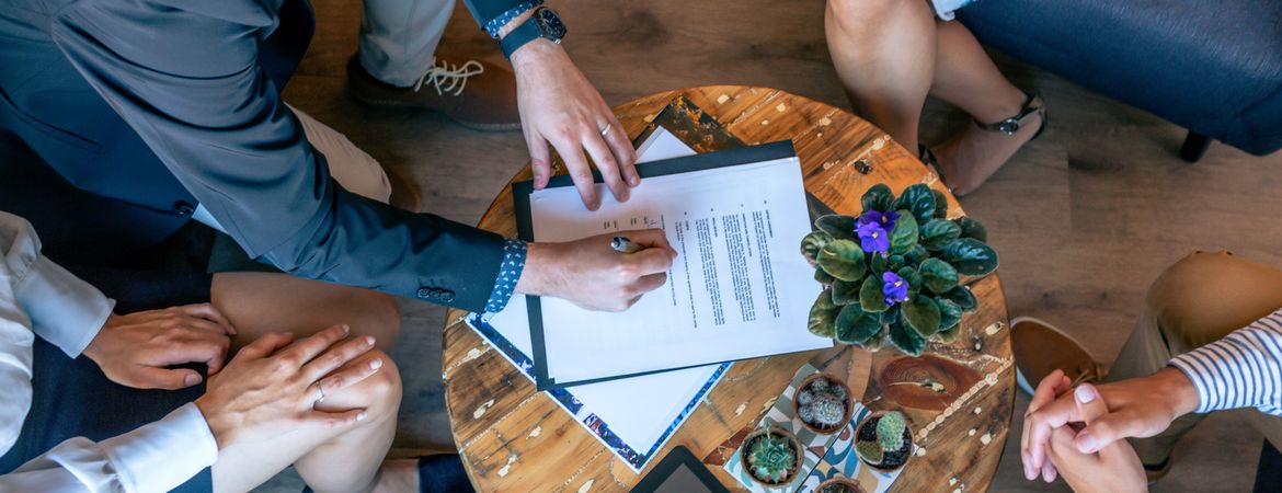 Top view of man signing a document
