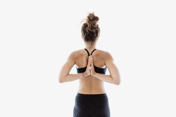 Sportive woman performing yoga pose in room