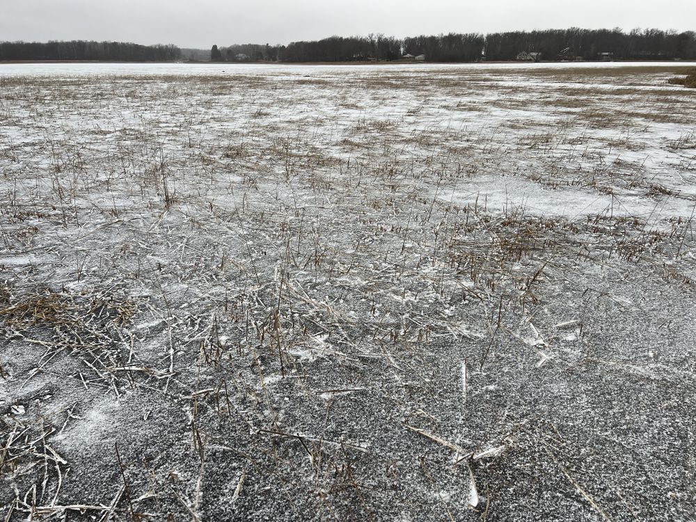 Big Sandy Lake with ice and light snow in McGregor, Minnesota