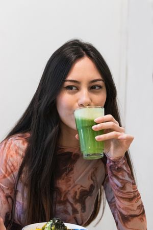 Woman drinking smoothie in restaurant