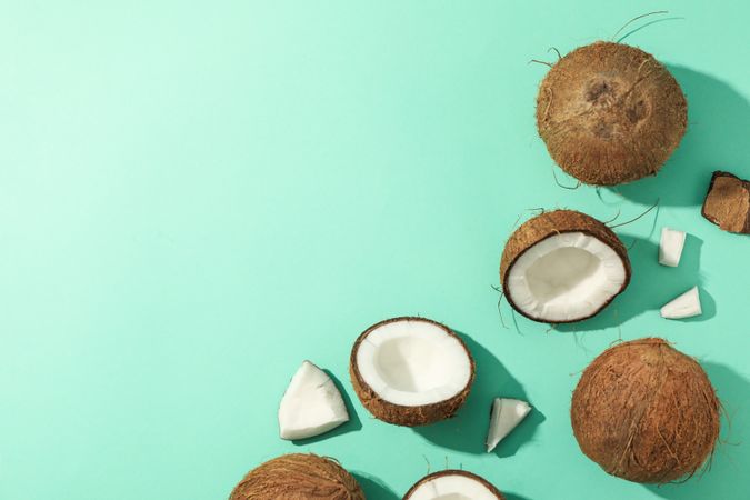 Flat lay with coconut on mint background, top view