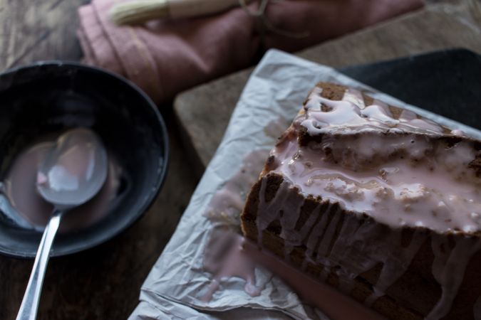 spoon pouring creme on delicious orange cake