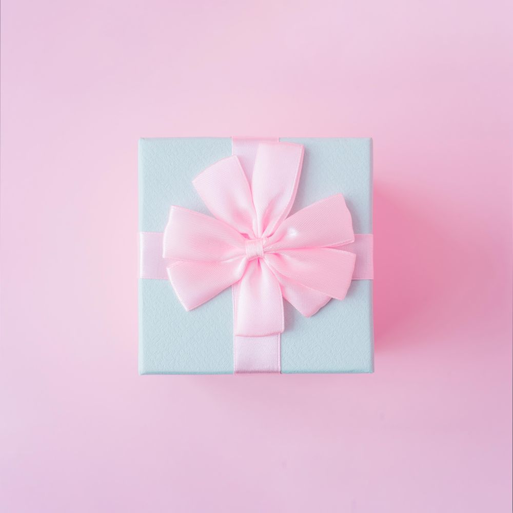 Top view of baby blue jewelry gift box on pastel backdrop