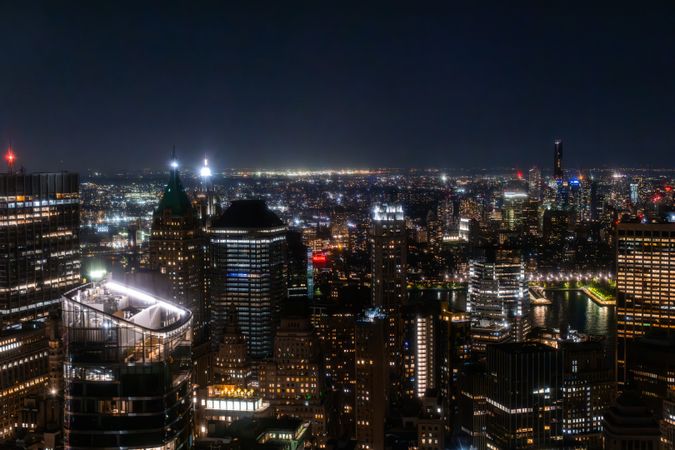 New York City Aerial Night Cityscape with Stunning Manhattan Landmarks, Skyscrapers and Residential Buildings. Wide Angle Panoramic Helicopter View of a Popular Travel Destination