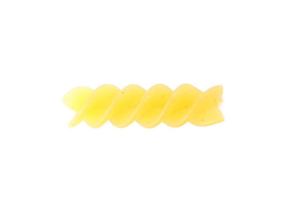 Pasta isolated on light background, closeup. Dry raw whole pasta