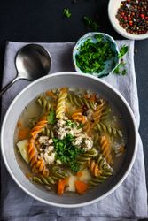 Top view of healthy soup with spinach pasta and meat balls served on the table with copy space