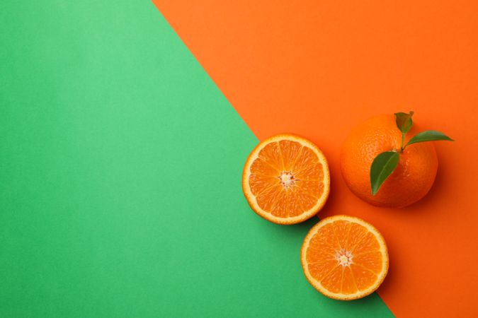 Ripe mandarins on two tone background, top view