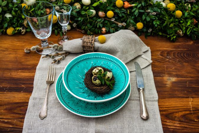 Easter table setting with bird nest in teal bowl