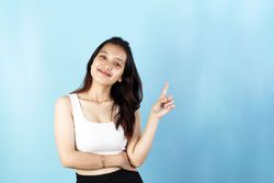 Bareface Asian Woman Wearing Tanktop Pointing up
