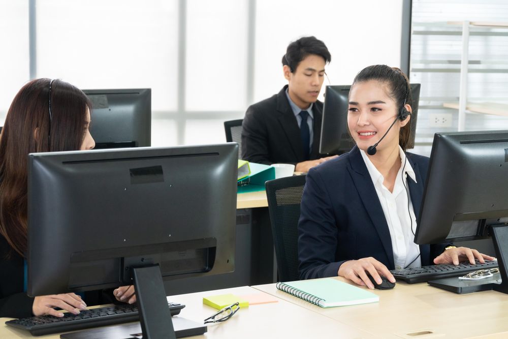Group of call center employees working in the office