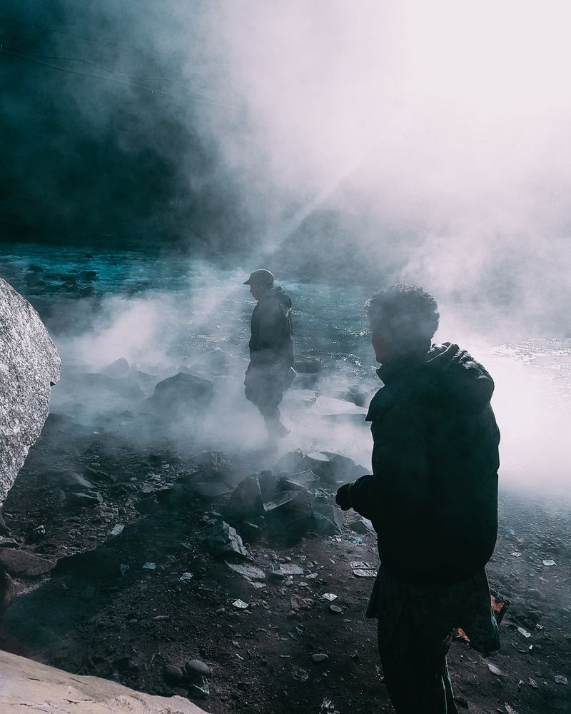 Two men standing in the mist
