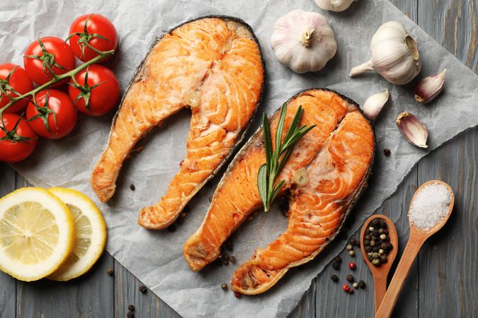 Composition with tasty grilled salmon on wooden background, top view