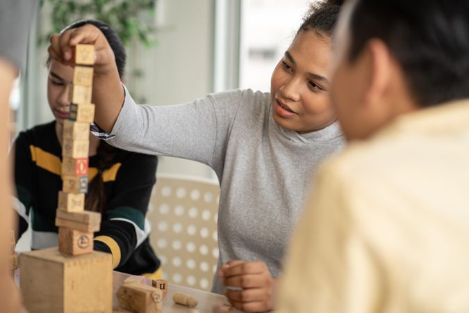 Female students using building blocks in class