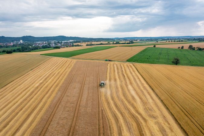 Aerial view of a combine harvesting crop in Germany in the evening