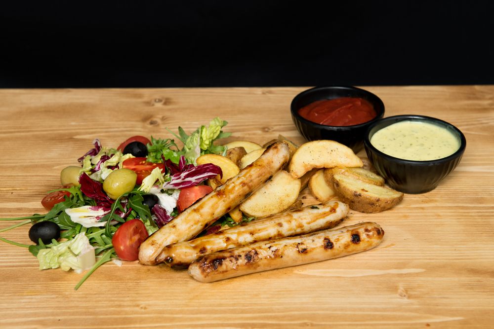 Fried meat and vegetables near ketchup