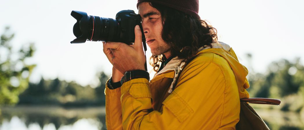Close up of a man taking a photo using a digital camera