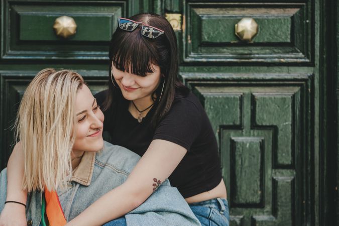 Lesbian couple sitting near door
