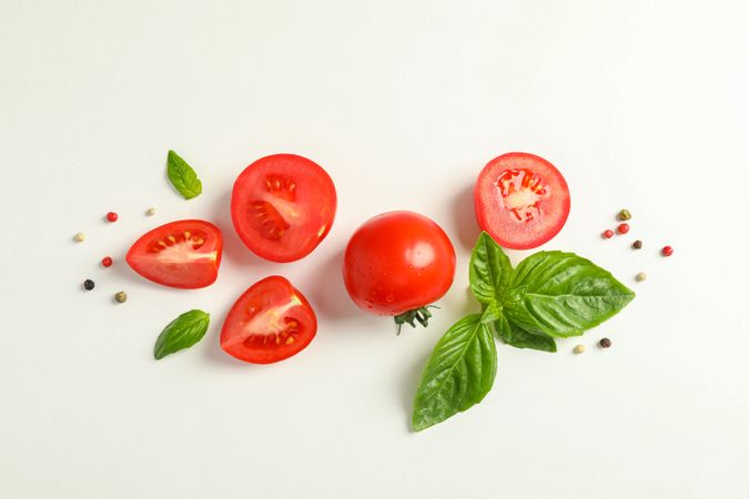 Flat lay composition with fresh cherry tomatoes, pepper and basil on blank background, space for text. Ripe vegetables